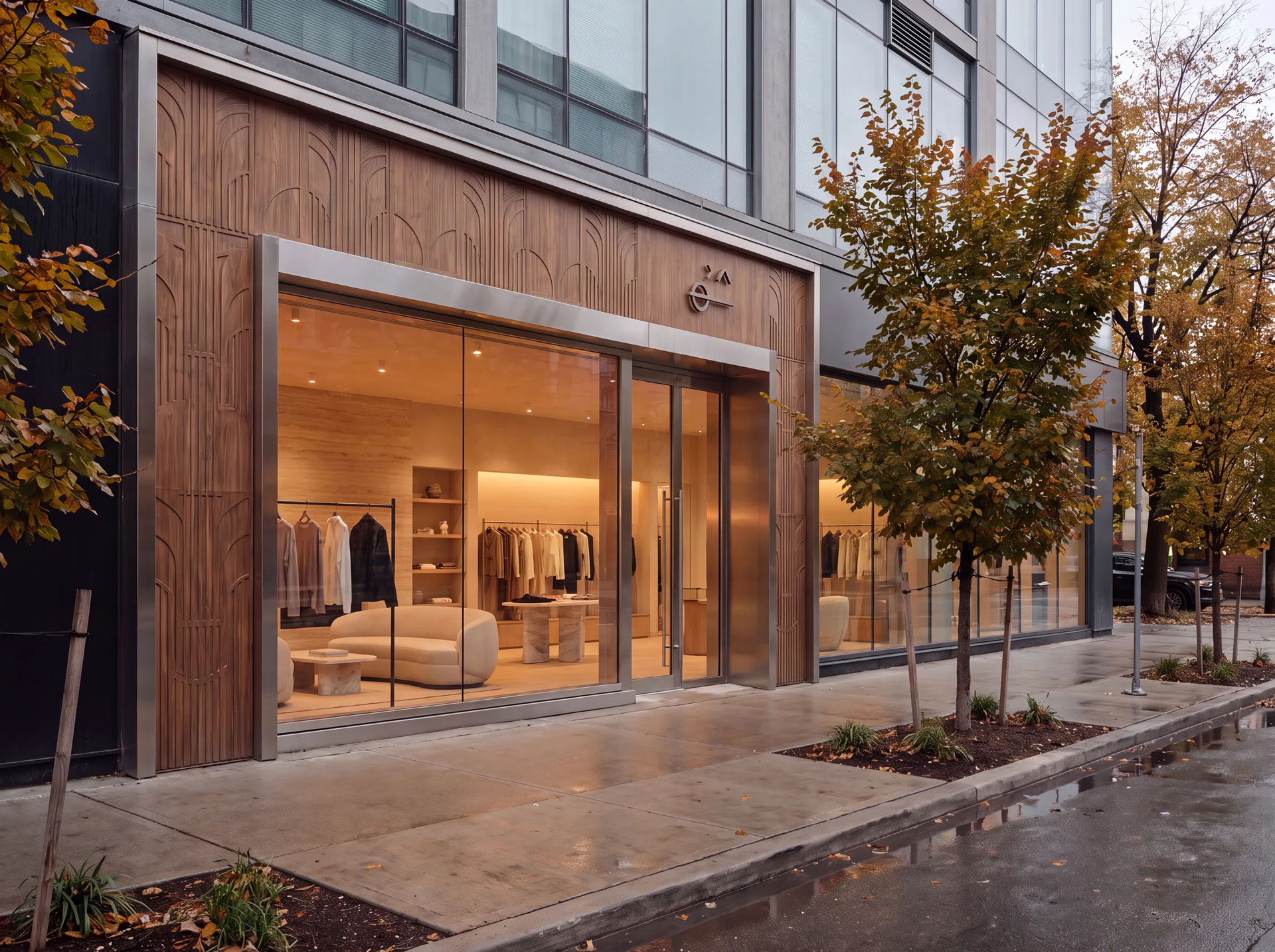 Minimal storefront with warm wood detailing, full-height glazing, and softly illuminated retail displays